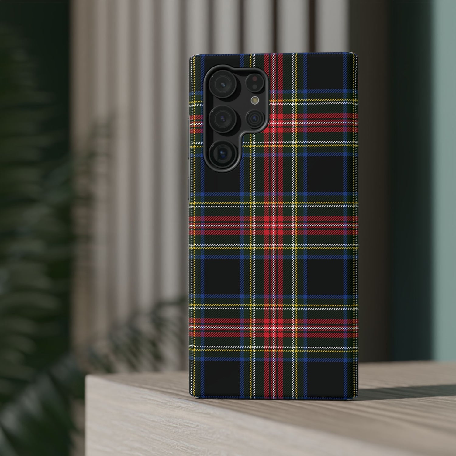 A phone case with a Christmas-themed tartan plaid pattern in black, red, and green, featuring a camera module on the back.