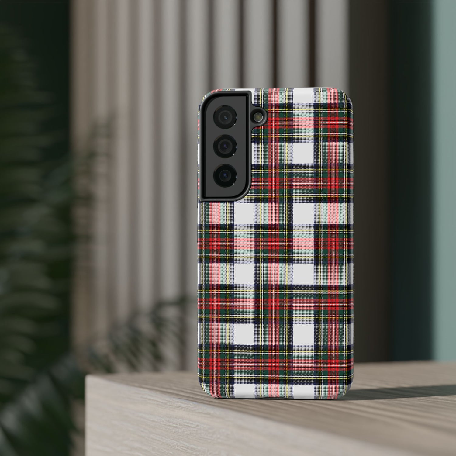 A phone case with a red and black tartan pattern design, featuring a camera module on the back and a glossy finish.